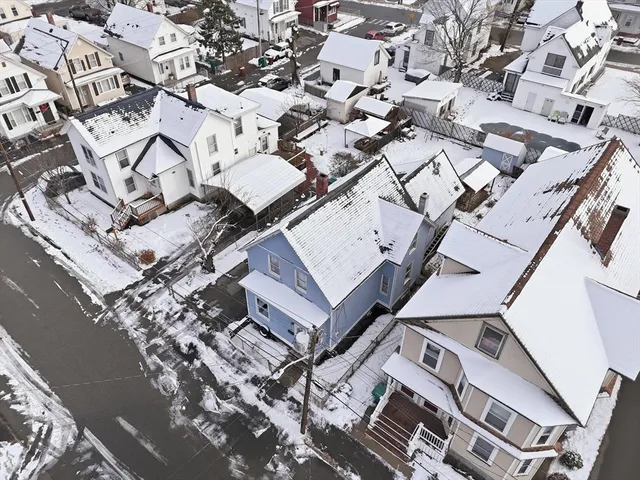 an aerial view of a house with a yard