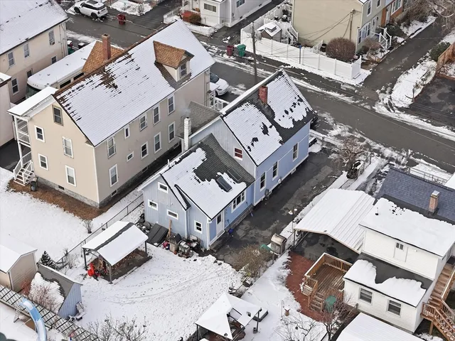 an aerial view of a house with a big yard