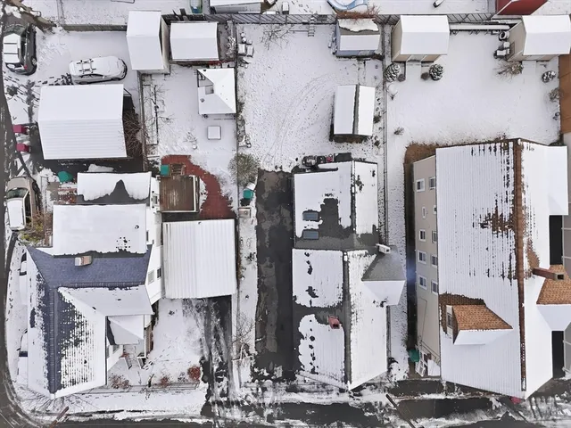 an aerial view of residential houses with outdoor space