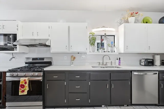 a kitchen with stainless steel appliances granite countertop a sink and cabinets