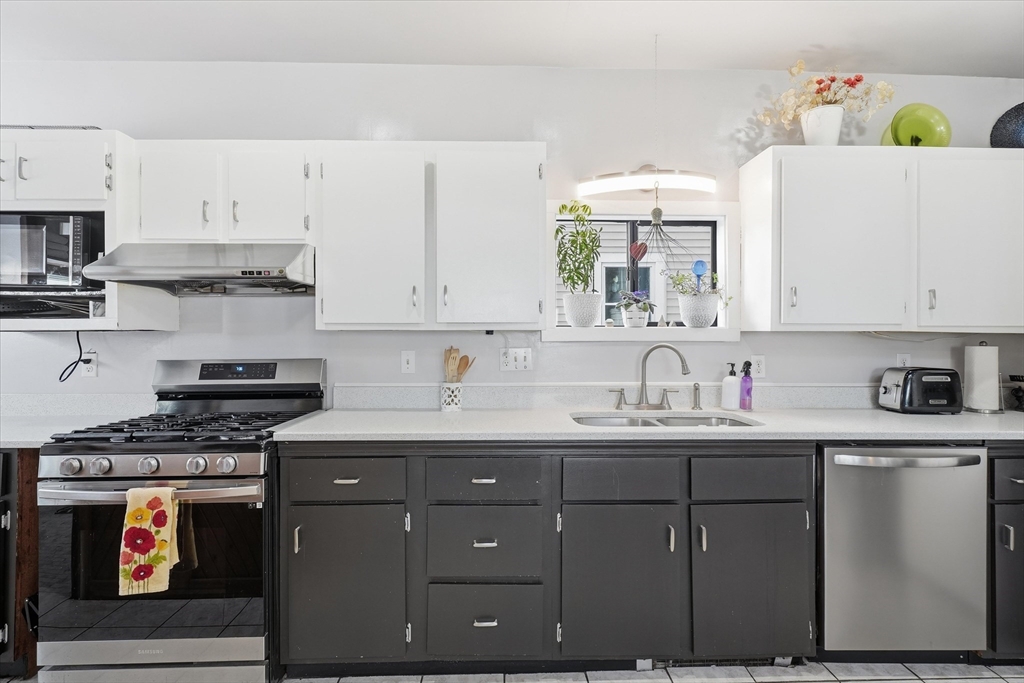 59 Fay Street Lowell, MA 01852 - Photo 4 of 33 a kitchen with stainless steel appliances granite countertop a sink and cabinets