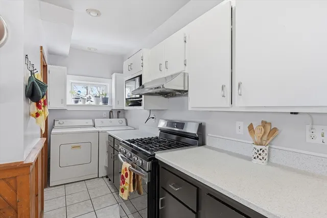 a kitchen with stainless steel appliances a sink stove and cabinets