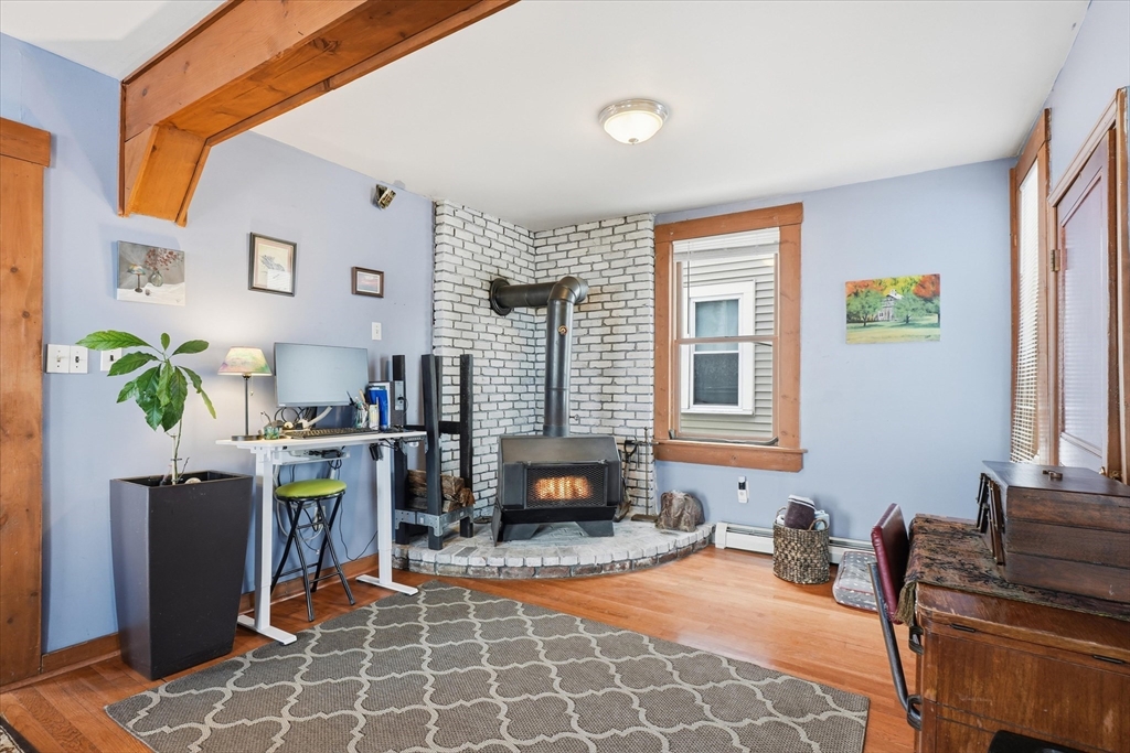 59 Fay Street Lowell, MA 01852 - Photo 10 of 33 a living room with furniture a window and a fireplace