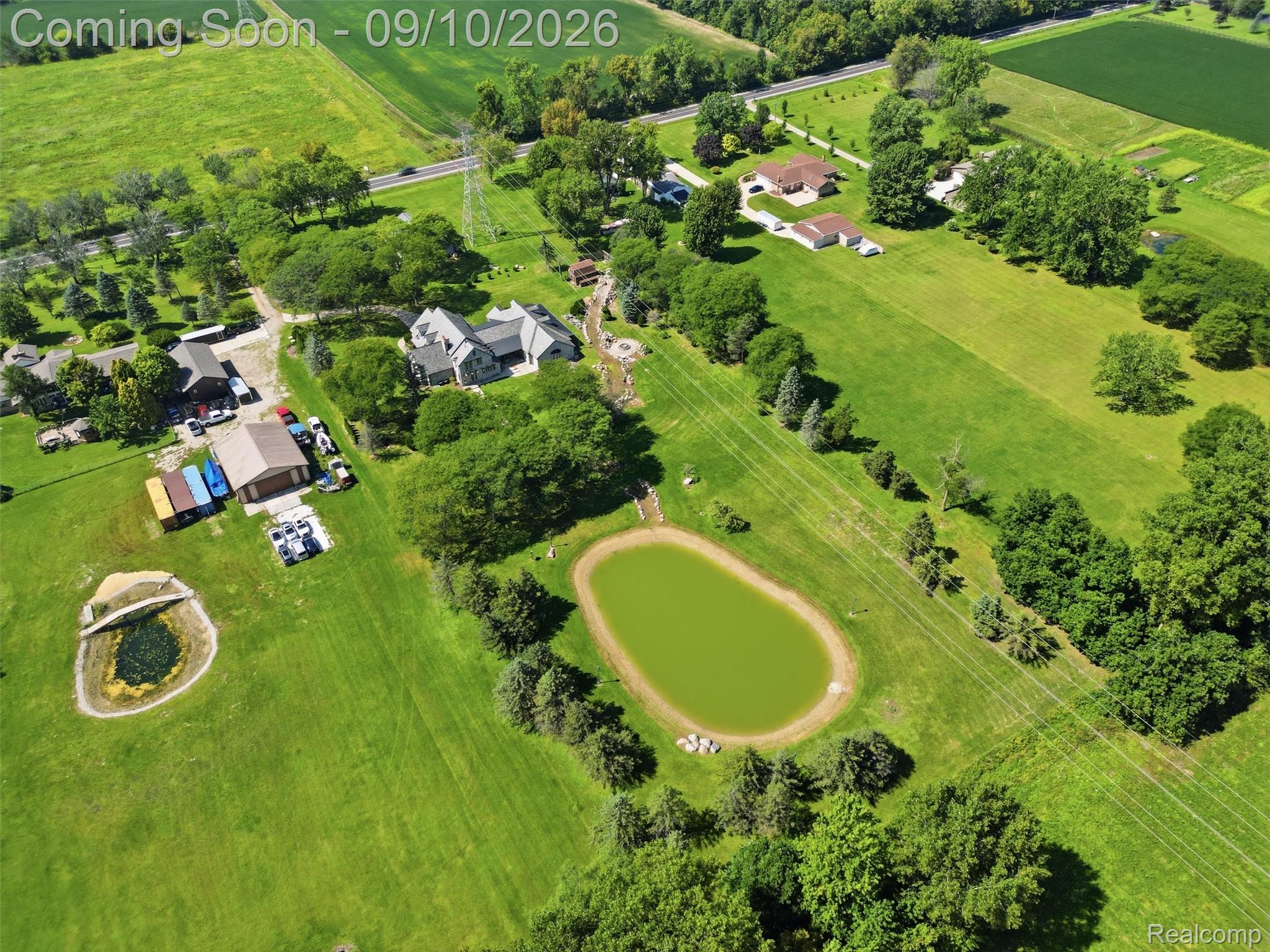 61400 Romeo Plank Road Ray, MI 48096 - Photo 16 of 99 Expansive property featuring a main residence, accessory structures, and two ponds set within a verdant landscape