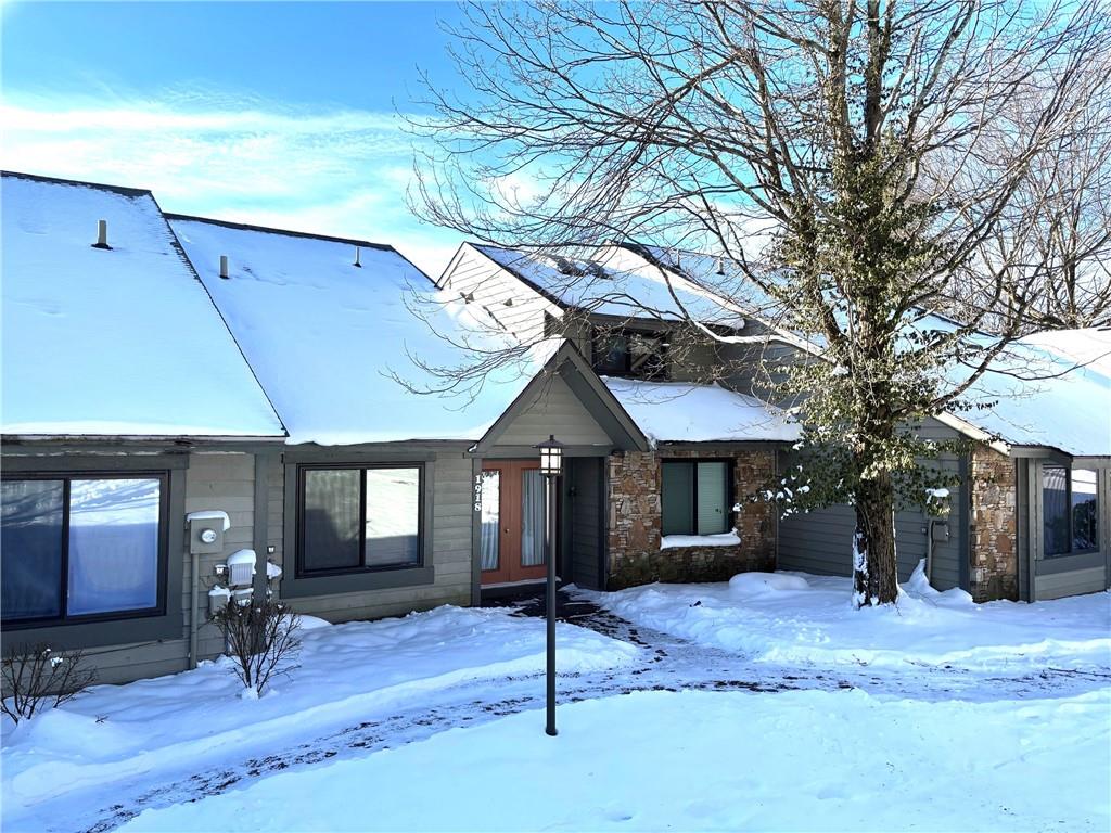 a house view with a sitting space fire pit and outdoor space