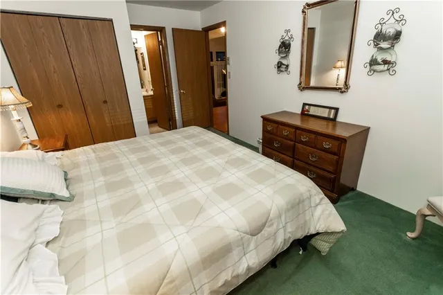 a bedroom with a bed chair and window