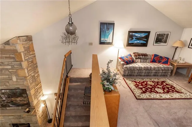 a bedroom with a bed wooden floor and lamp