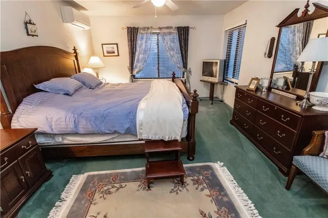 a bedroom with a bed and a mirror