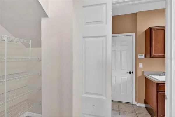 an empty room with a window and a ceiling fan