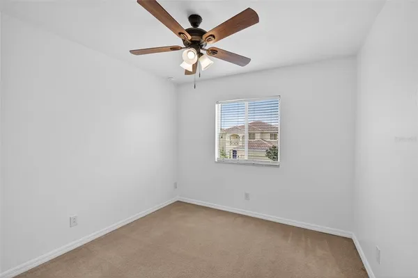 a view of a house with backyard and a tree