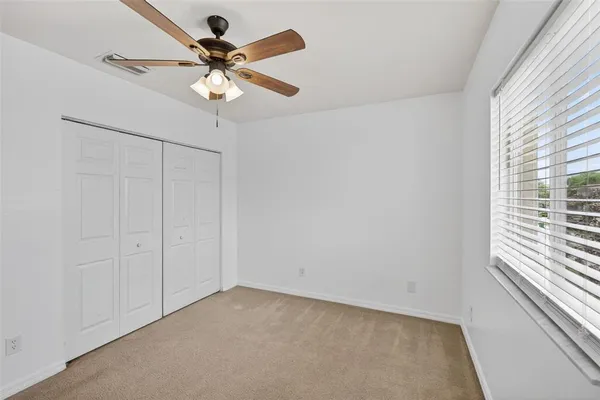 a view of a yard in front of a house with a large tree