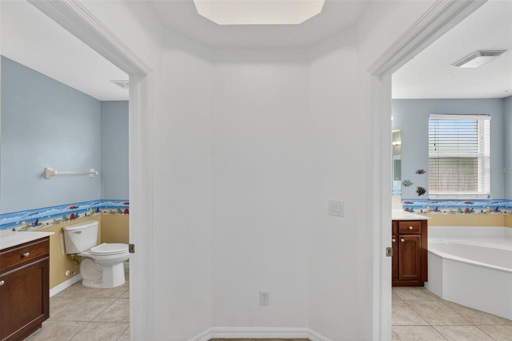 4197 River Bank Way Punta Gorda, FL 33980 - Photo 47 of 73 a bathroom with a granite countertop toilet a sink and a mirror
