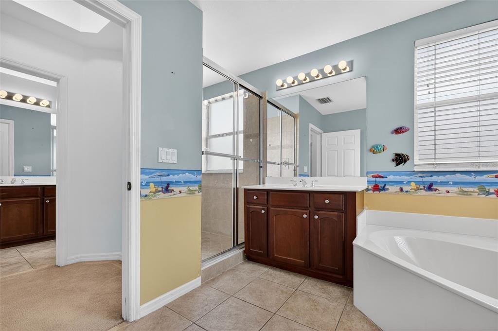4197 River Bank Way Punta Gorda, FL 33980 - Photo 49 of 73 a spacious bathroom with a tub sink and mirror