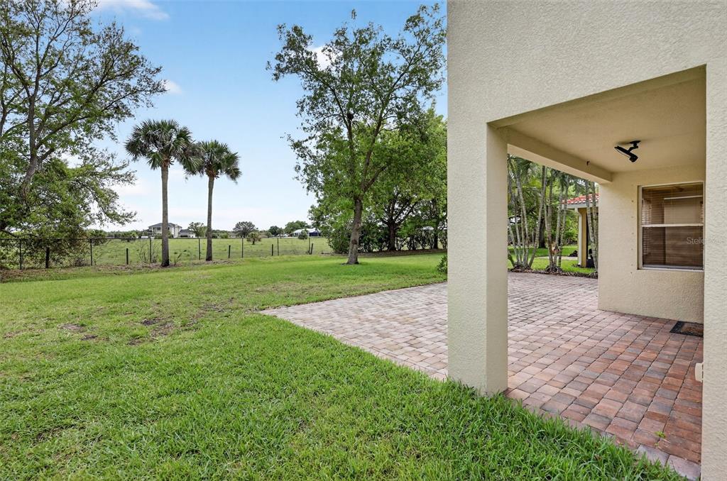 4197 River Bank Way Punta Gorda, FL 33980 - Photo 54 of 73 a view of a house with backyard and a tree