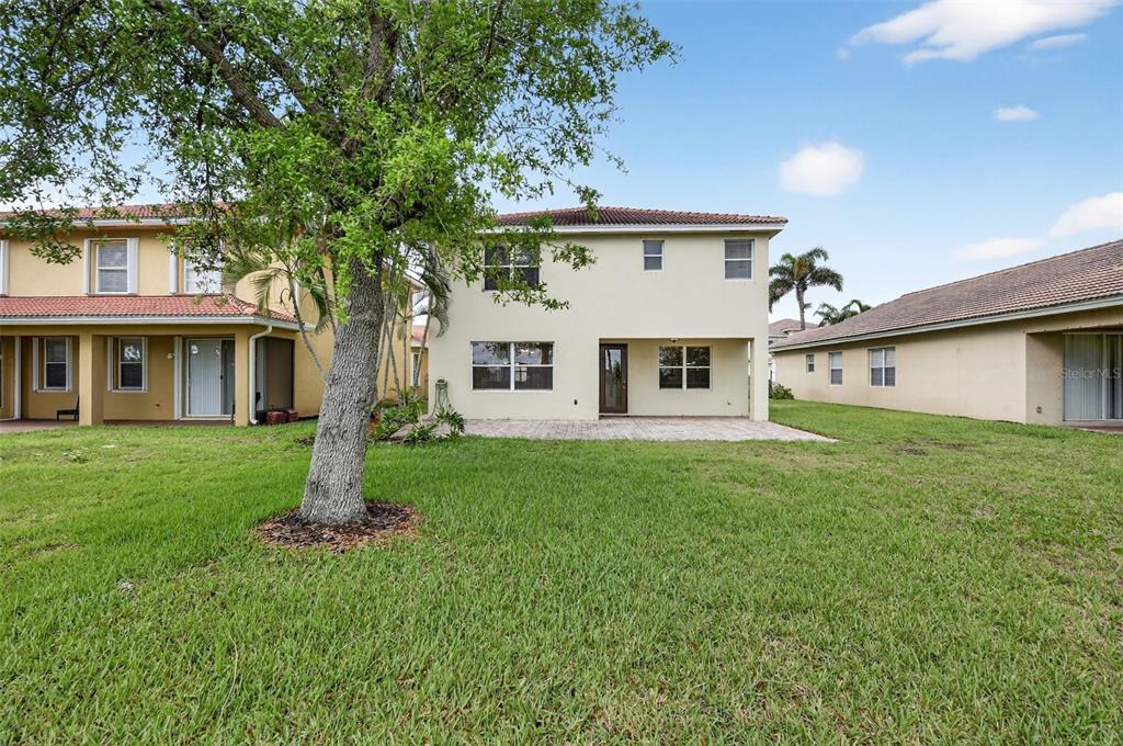 4197 River Bank Way Punta Gorda, FL 33980 - Photo 58 of 73 a view of a yard in front of a house with a large tree