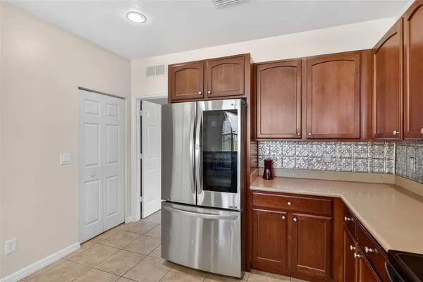 a kitchen with stainless steel appliances granite countertop a refrigerator sink and cabinets