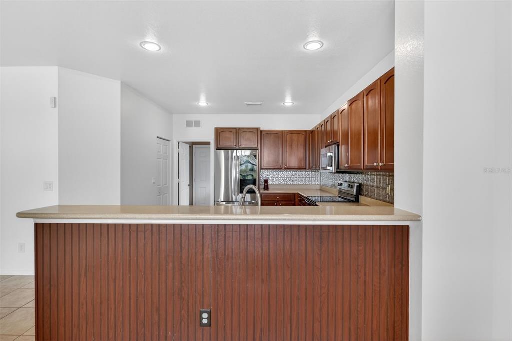 4197 River Bank Way Punta Gorda, FL 33980 - Photo 8 of 73 a kitchen with stainless steel appliances granite countertop a refrigerator sink and cabinets