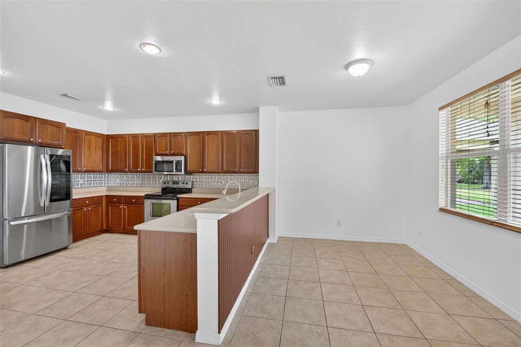 4197 River Bank Way Punta Gorda, FL 33980 - Photo 10 of 73 a large kitchen with a large counter top stainless steel appliances and cabinets