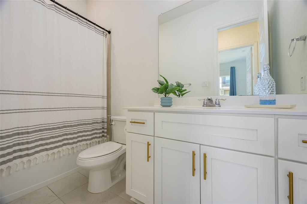 3603 Scotsman Road Sachse, TX 75048 - Photo 22 of 33 a bathroom with a sink a toilet a mirror and shower