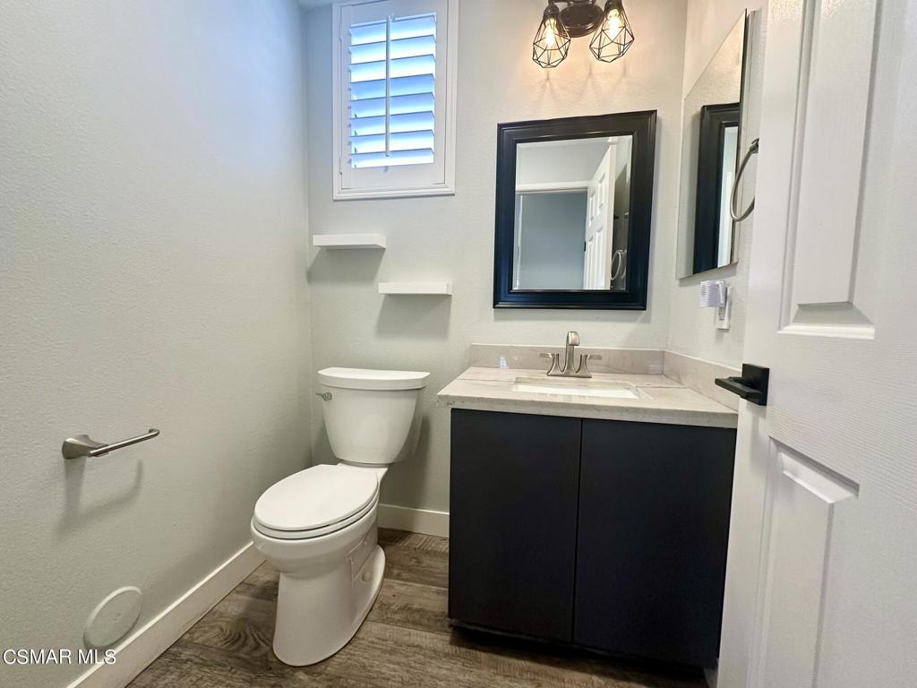111 Macademia Lane Simi Valley, CA 93065 - Photo 13 of 38 a bathroom with a toilet sink vanity and mirror