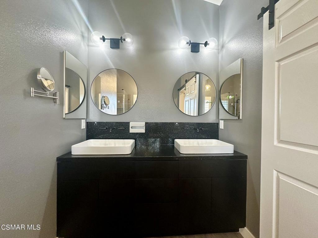 111 Macademia Lane Simi Valley, CA 93065 - Photo 23 of 38 a bathroom with double vanity and a mirror