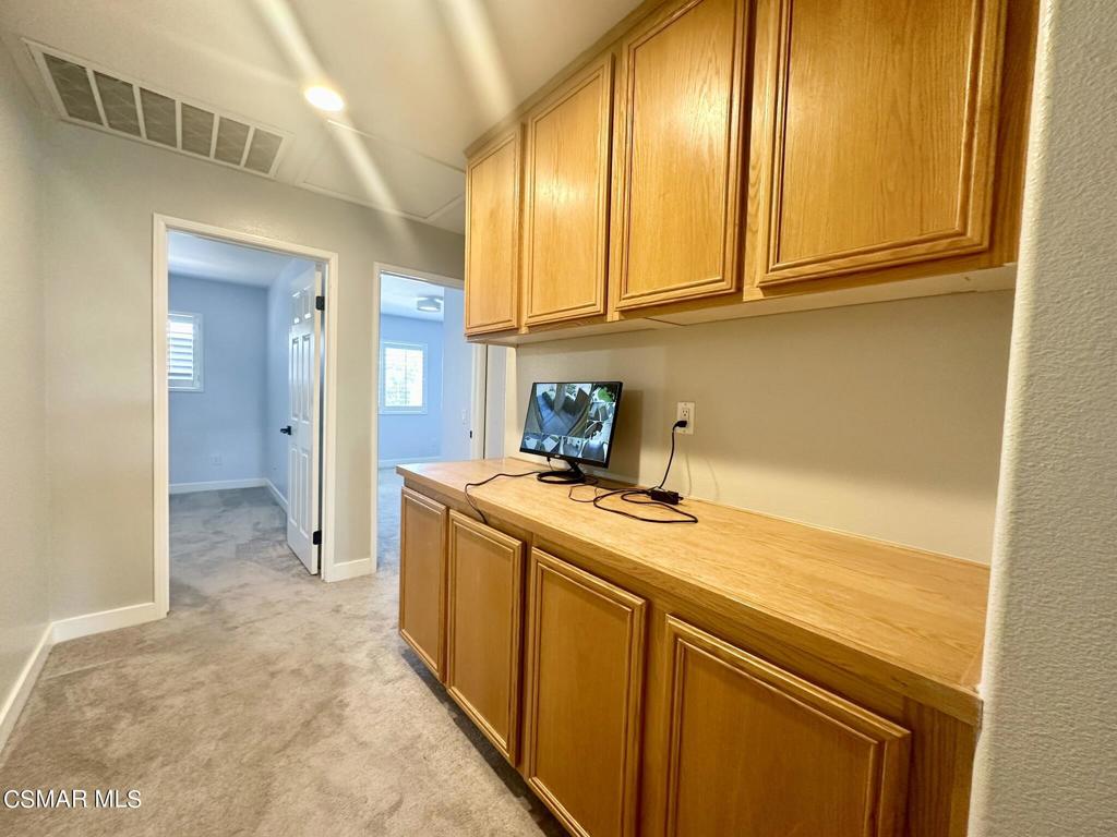 111 Macademia Lane Simi Valley, CA 93065 - Photo 27 of 38 a view of a kitchen with stainless steel appliances granite countertop furniture a washer and dryer
