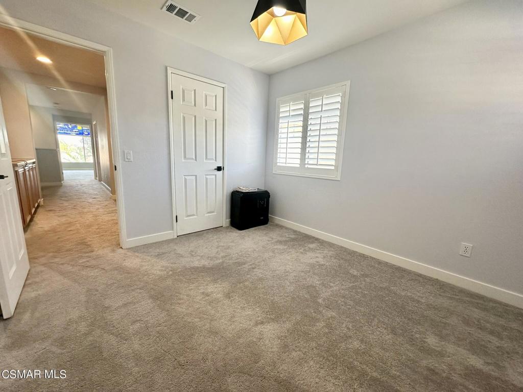 111 Macademia Lane Simi Valley, CA 93065 - Photo 28 of 38 an empty room with a window and wooden floor