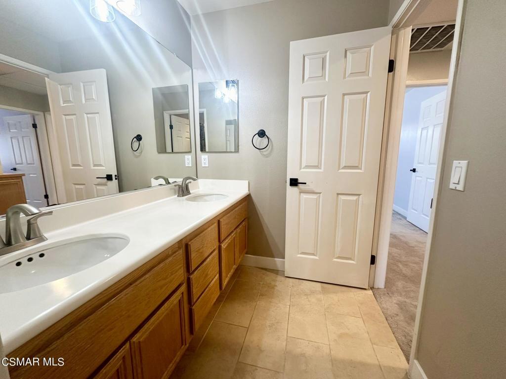 111 Macademia Lane Simi Valley, CA 93065 - Photo 32 of 38 a spacious bathroom with a double vanity sink a mirror and a shower
