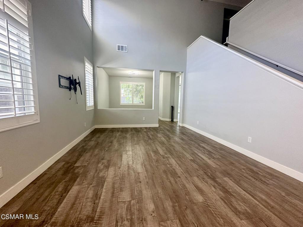111 Macademia Lane Simi Valley, CA 93065 - Photo 4 of 38 an empty room with wooden floor and windows