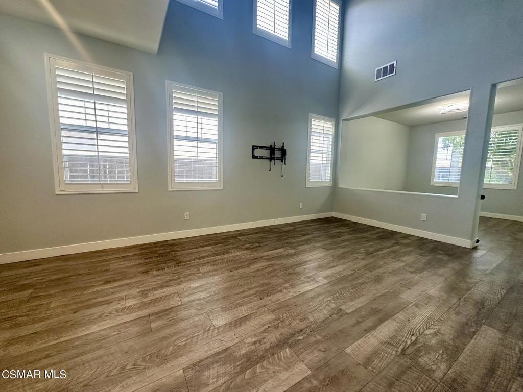 111 Macademia Lane Simi Valley, CA 93065 - Photo 5 of 38 an empty room with wooden floor and windows