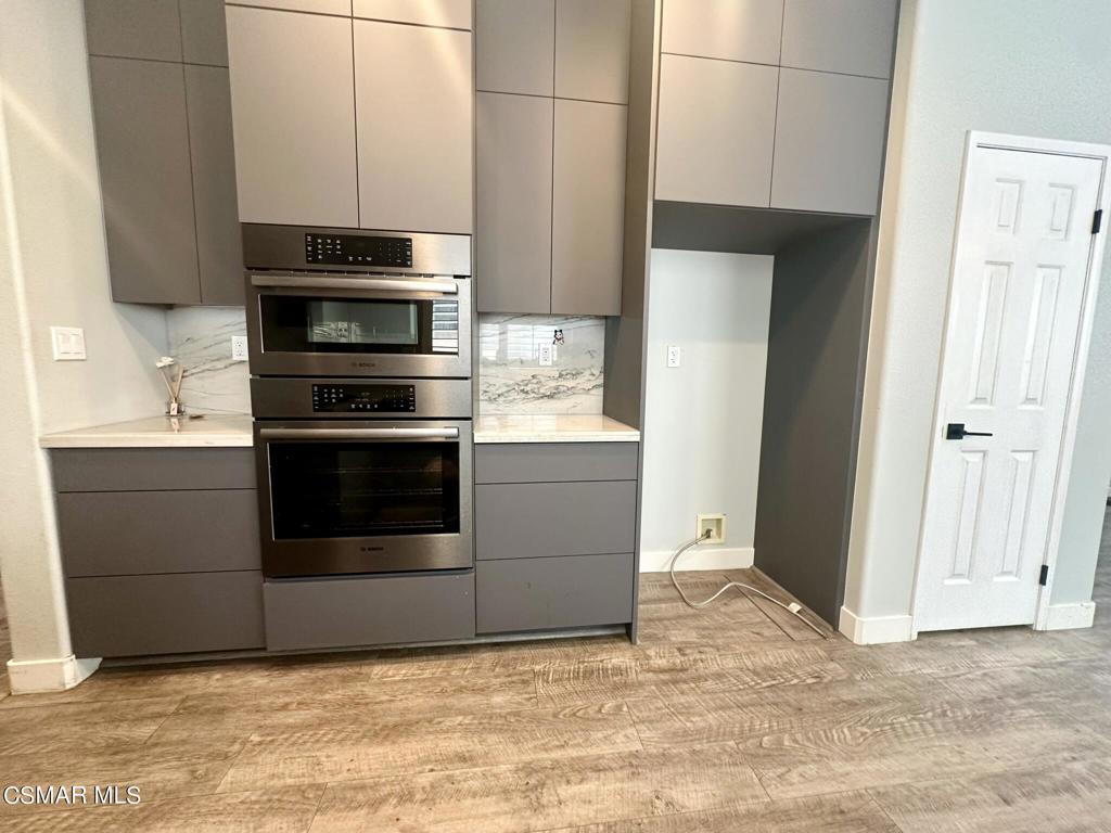 111 Macademia Lane Simi Valley, CA 93065 - Photo 9 of 38 a kitchen with stainless steel appliances a stove and a microwave