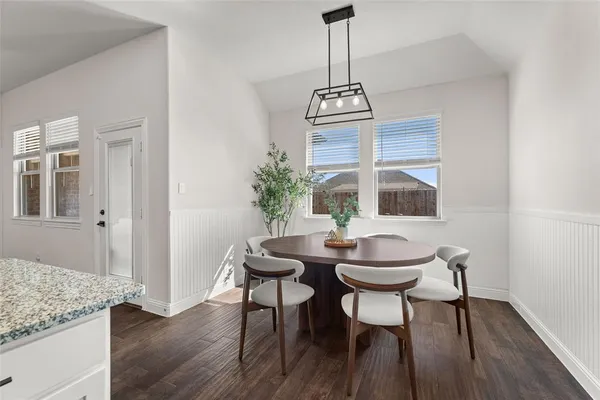 a view of a dining room with furniture window and wooden floor