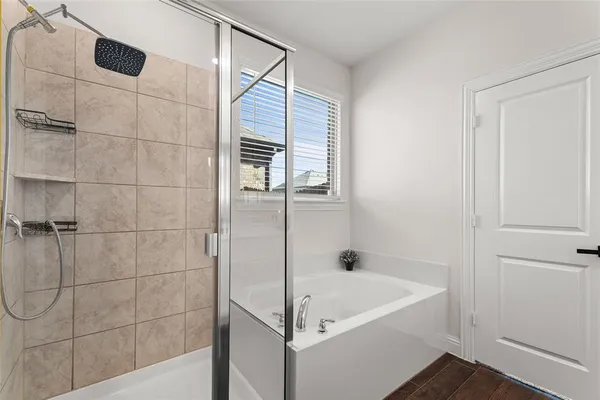a bathroom with a bathtub and shower