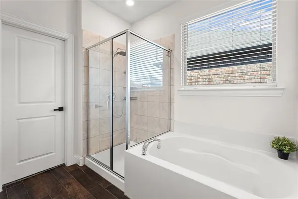 a bathroom with a bathtub and a shower