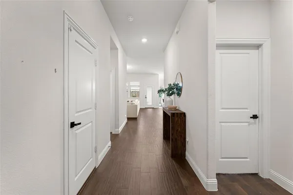 view of a hallway with wooden floor and closet