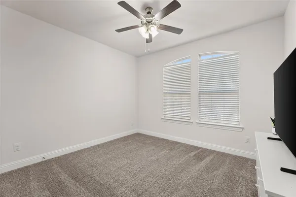 a view of a livingroom with a ceiling fan and a window