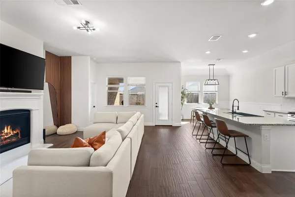 a living room with furniture wooden floor and a fireplace