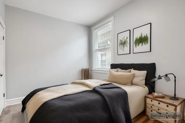 a bedroom with a bed and a window