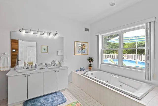 a spacious bathroom with sink shower and bathtub