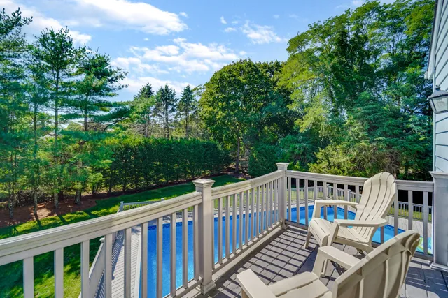 a view of a deck with furniture and trees