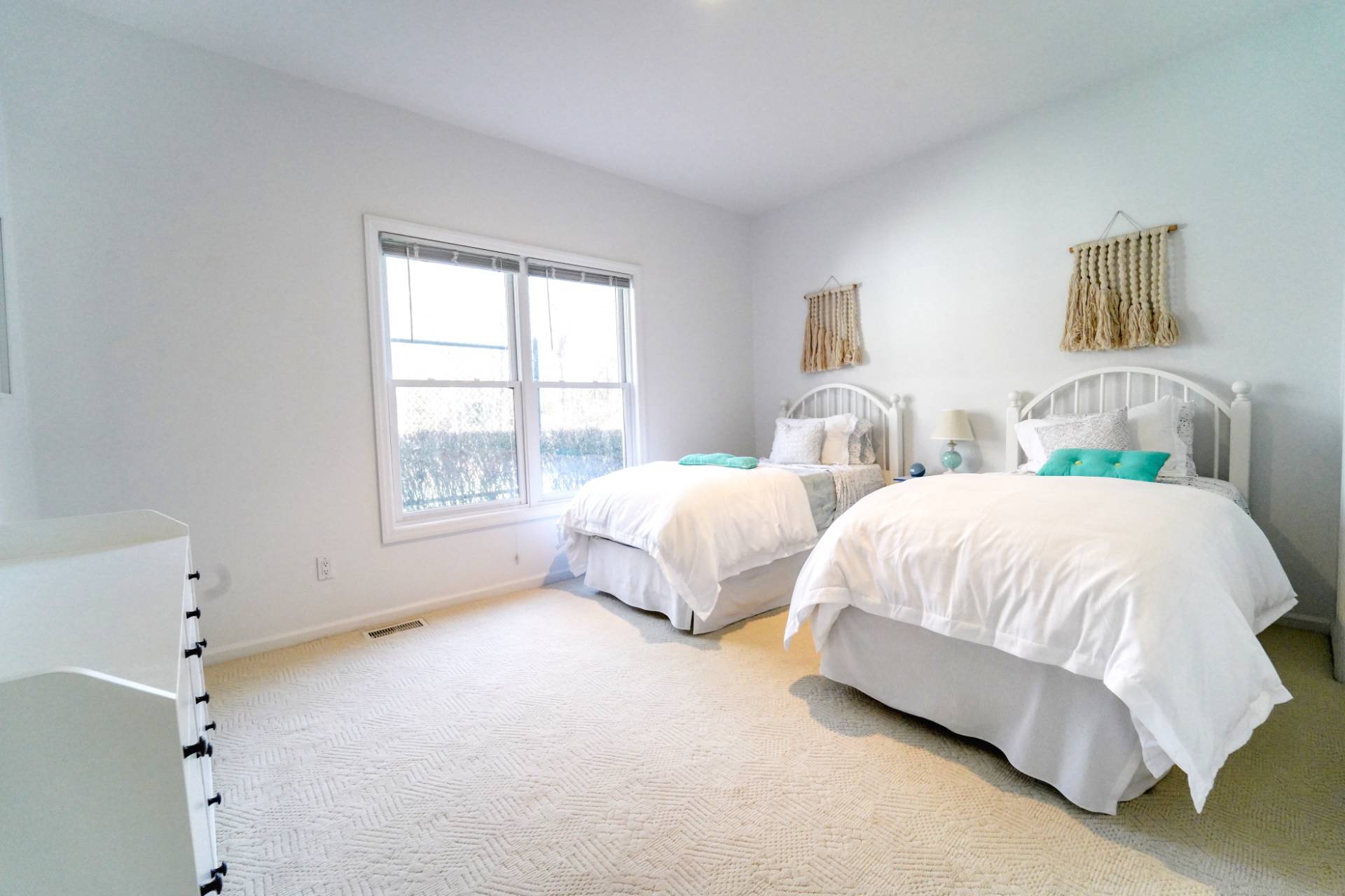 7 Plume Grass Way Westhampton, NY 11977 - Photo 18 of 23 a spacious bedroom with two bed and a window