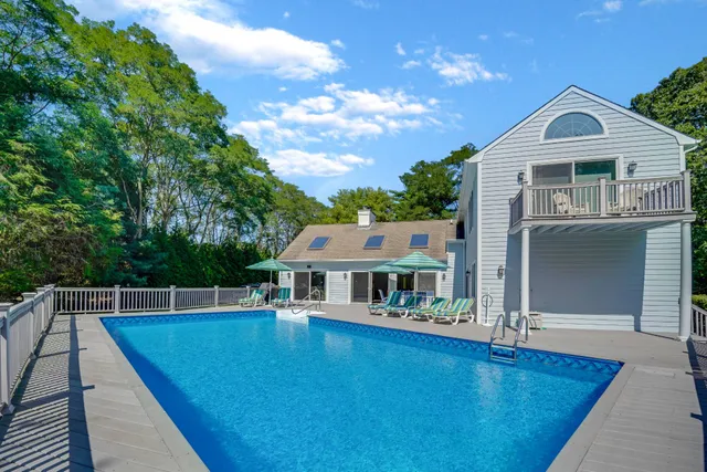 a view of house with swimming pool outdoor seating