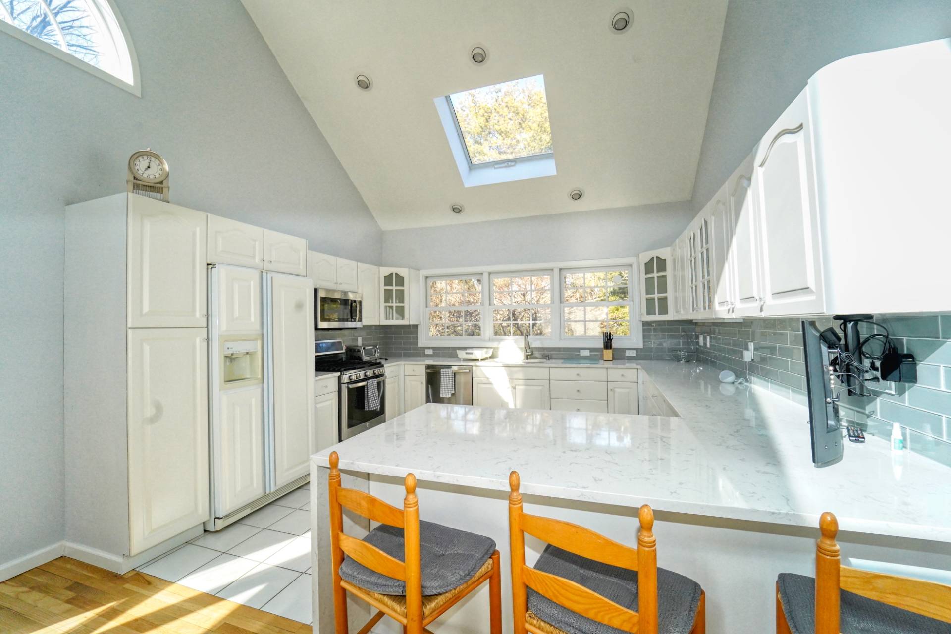 7 Plume Grass Way Westhampton, NY 11977 - Photo 7 of 23 a kitchen with stainless steel appliances granite countertop a sink a stove and a refrigerator