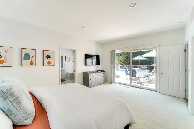 a large bedroom with a large bed and a tv