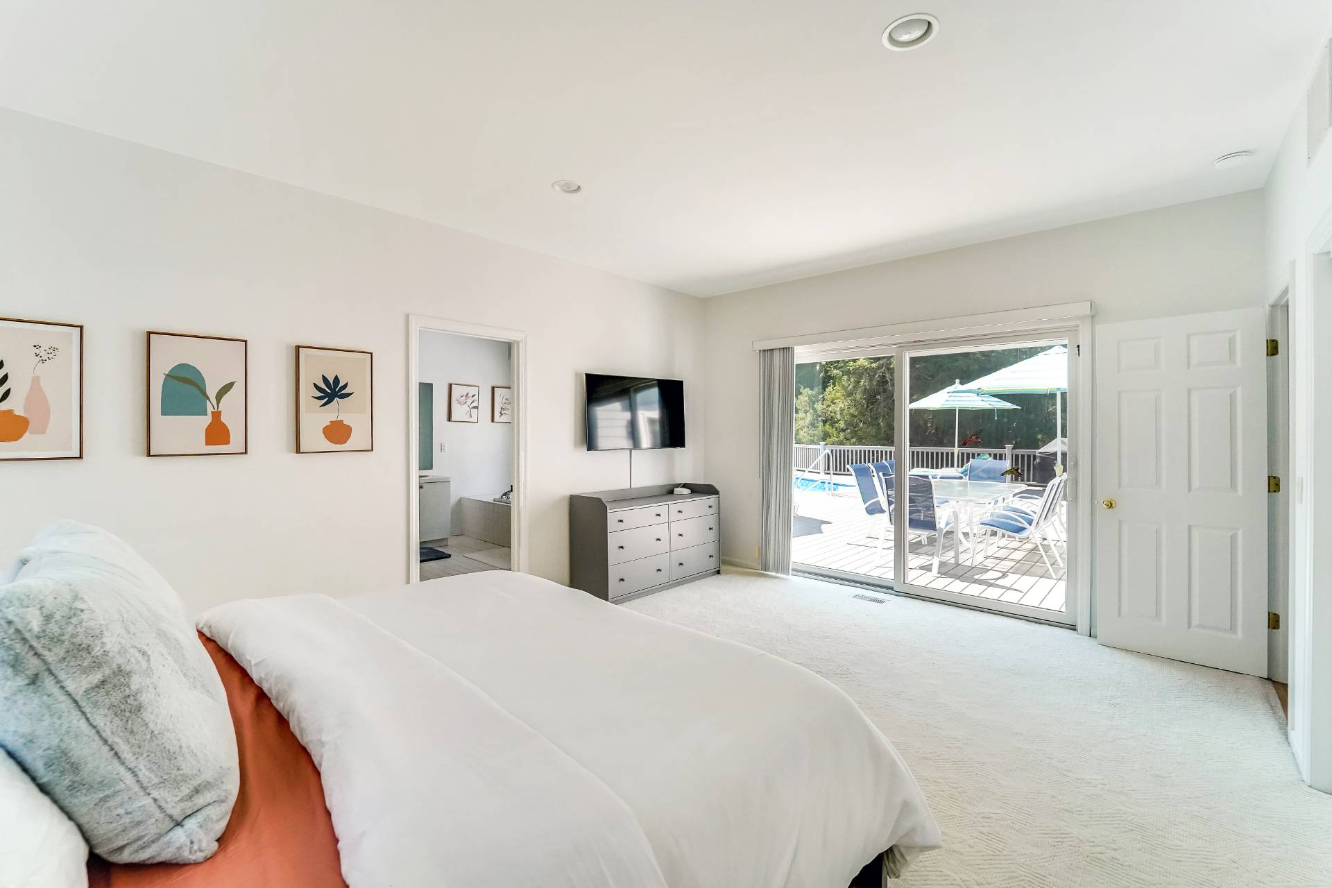 7 Plume Grass Way Westhampton, NY 11977 - Photo 10 of 23 a large bedroom with a large bed and a tv