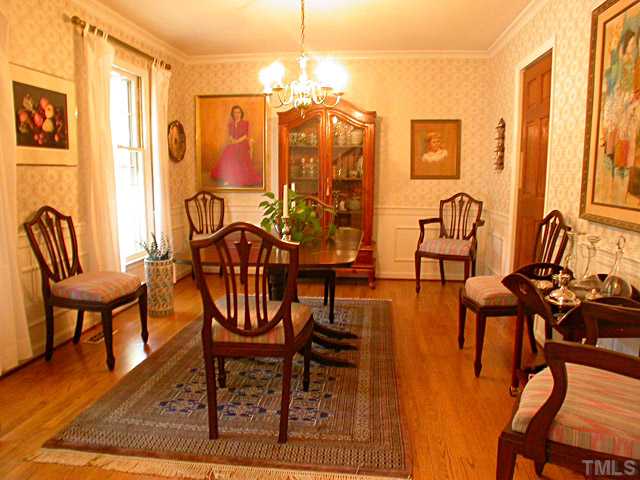6805 Garrison Court Raleigh, NC 27613 - Photo 4 of 12 Stunning Formal Dining Room is Spacious in size and has Beautiful Hardwood Floors, Crown Molding, Chairrail and Wainscoting with Classic Windowpane Molding