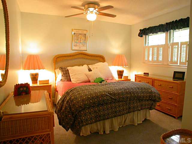 6805 Garrison Court Raleigh, NC 27613 - Photo 8 of 12 Secondary Bedroom has Double Closet, Window Shutters and Ceiling Fan