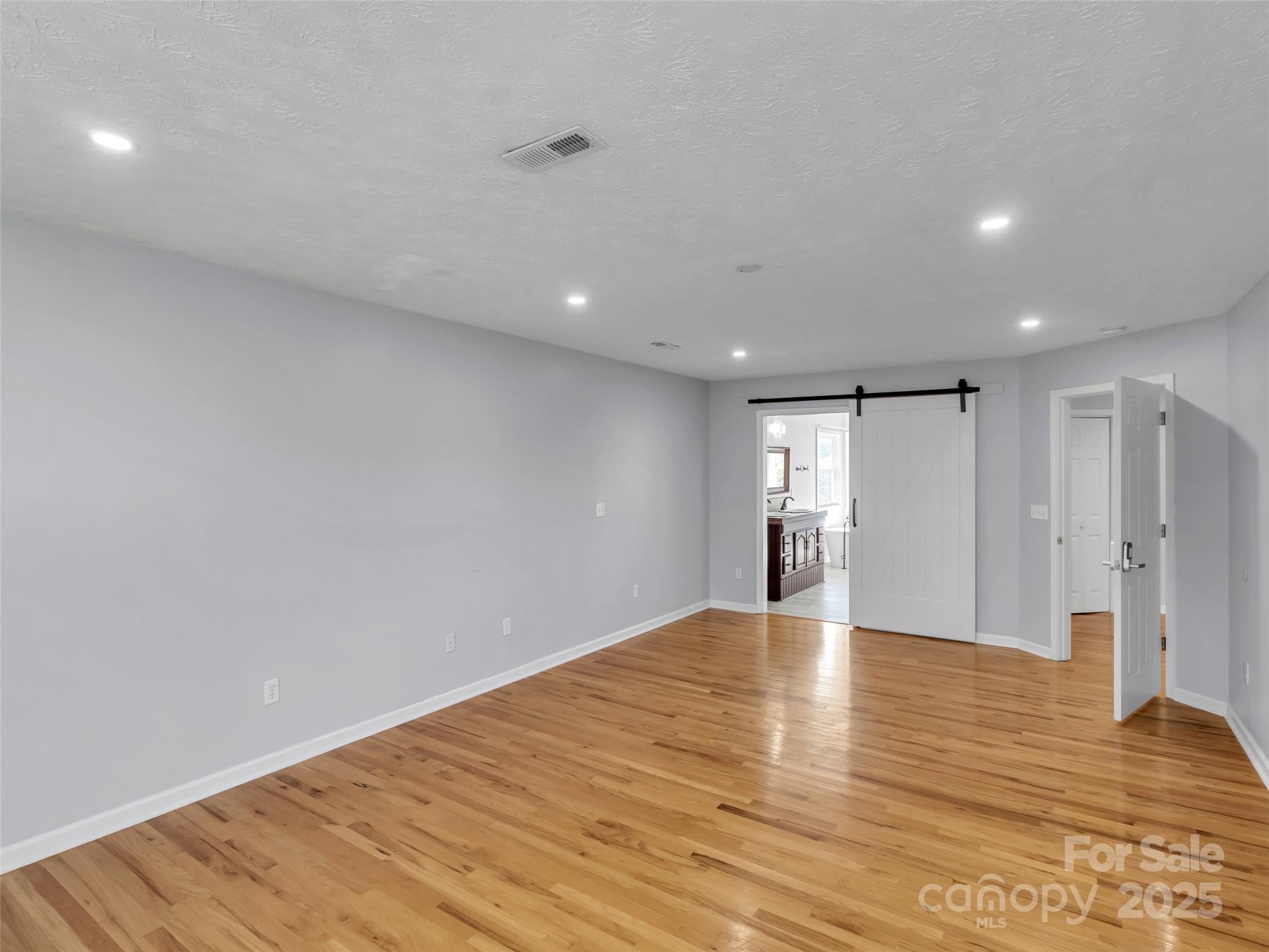 235 Loop Road Clyde, NC 28721 - Photo 9 of 21 a view of empty room with wooden floor
