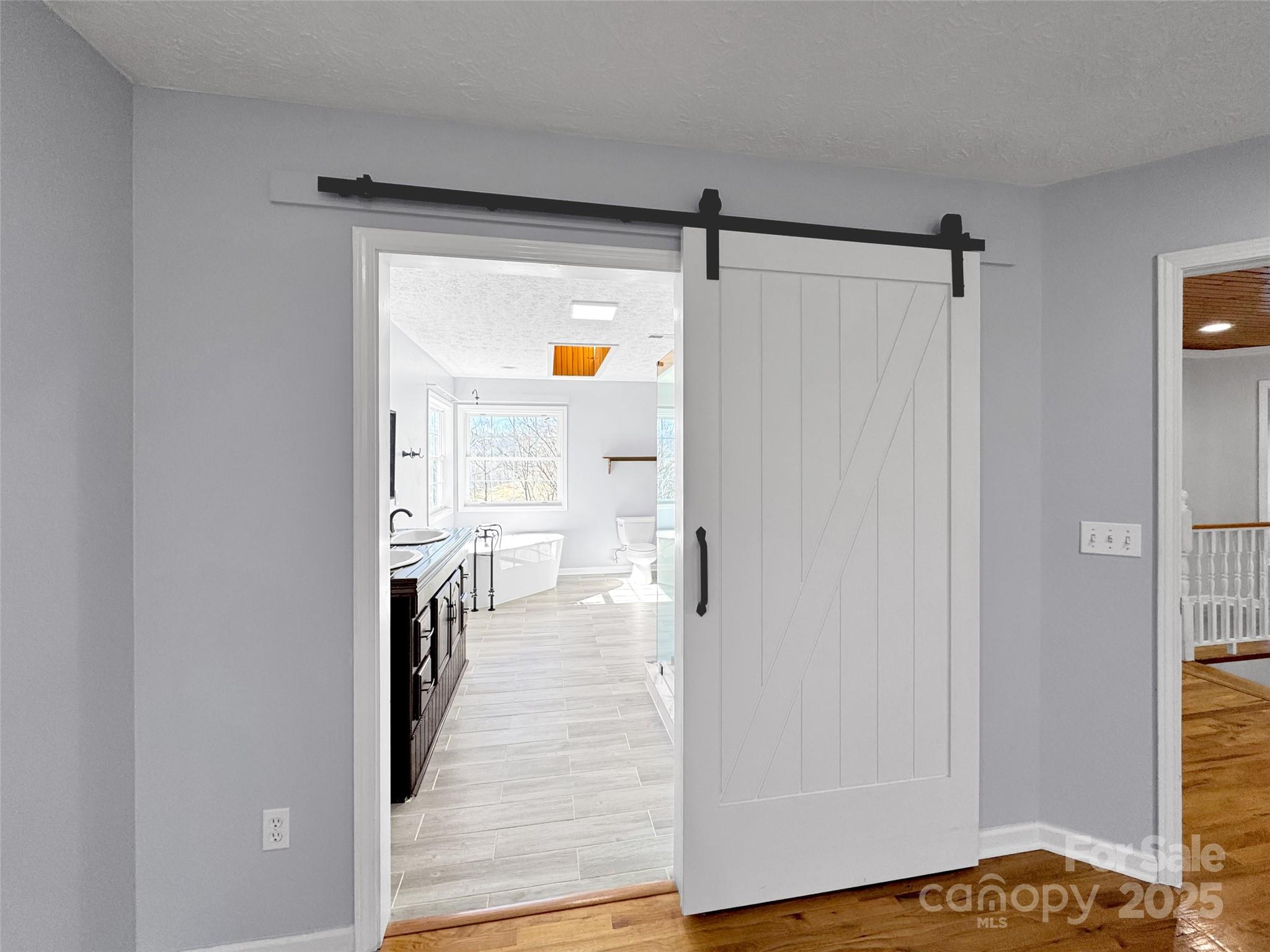 235 Loop Road Clyde, NC 28721 - Photo 10 of 21 a view of a hallway with wooden floor and cabinet