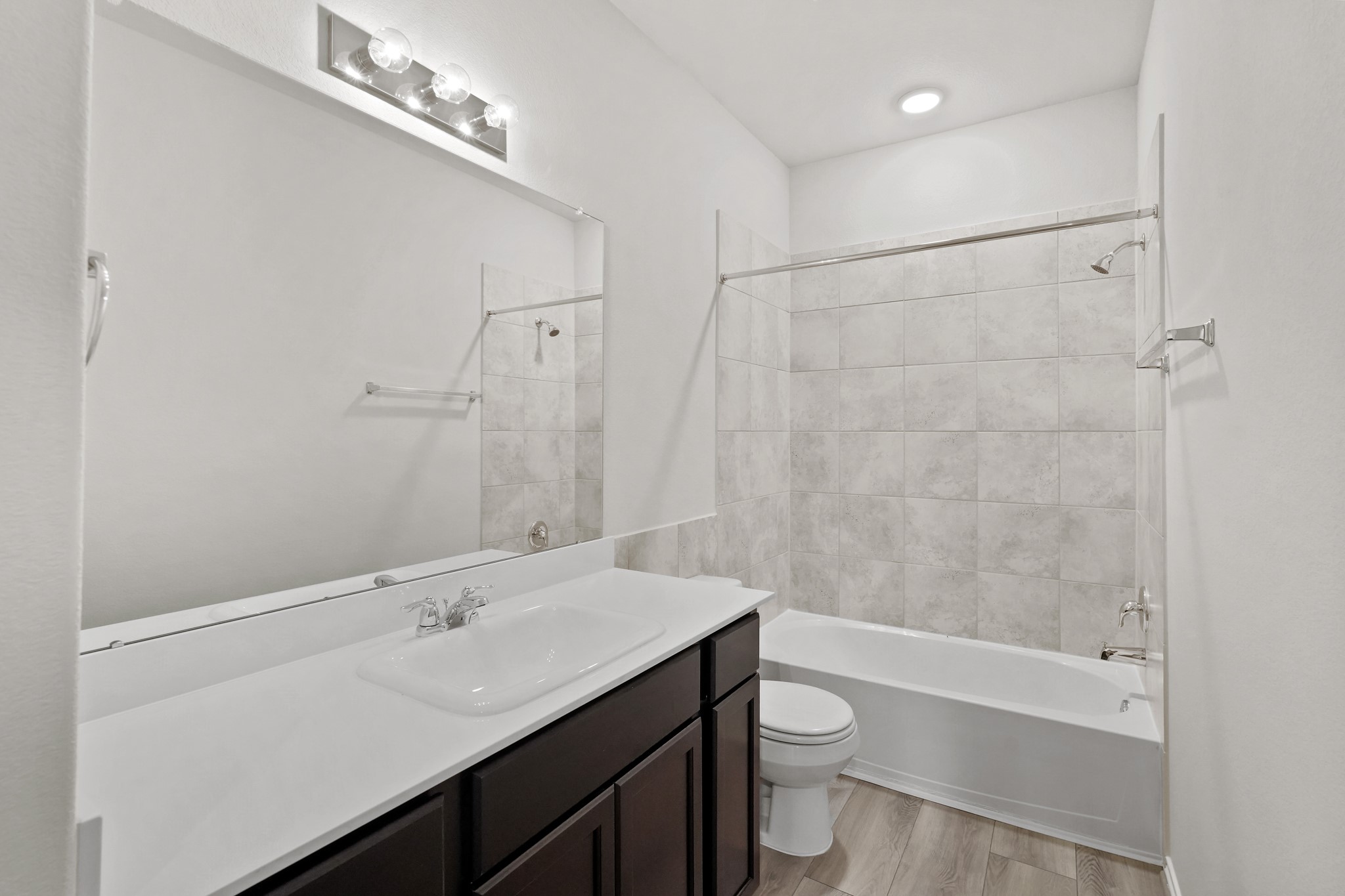 1407 Acorn Meadow Street Houston, TX 77067 - Photo 13 of 22 a bathroom with a sink a toilet a shower and a mirror